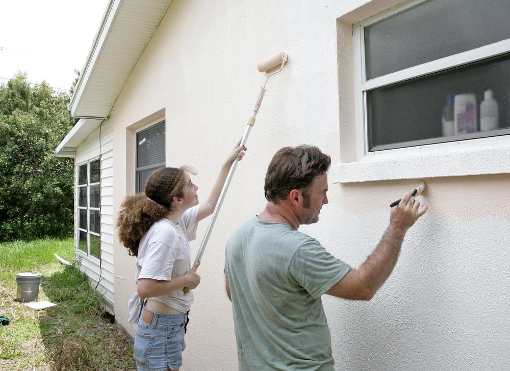 people painting stucco